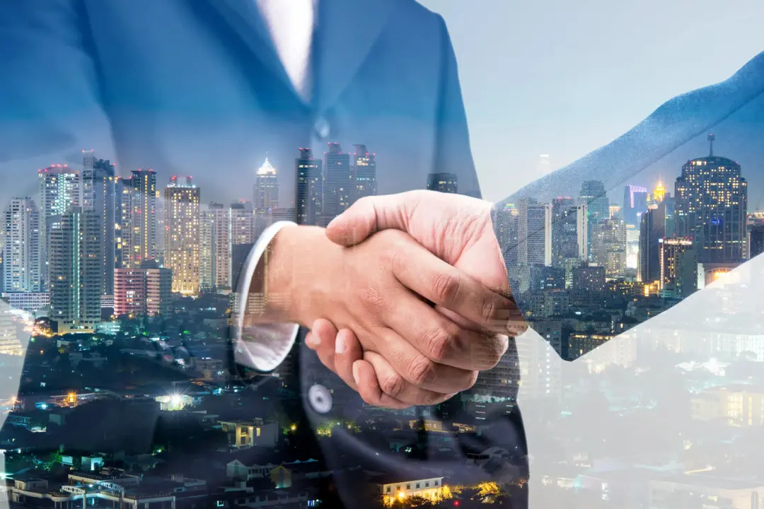 City Background with two businessmen shaking hands